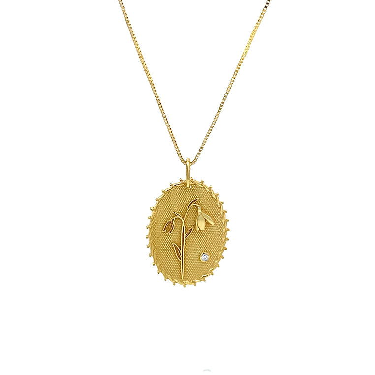 A gold necklace with an Snowdrop flower design and a small diamond set with a diamond.