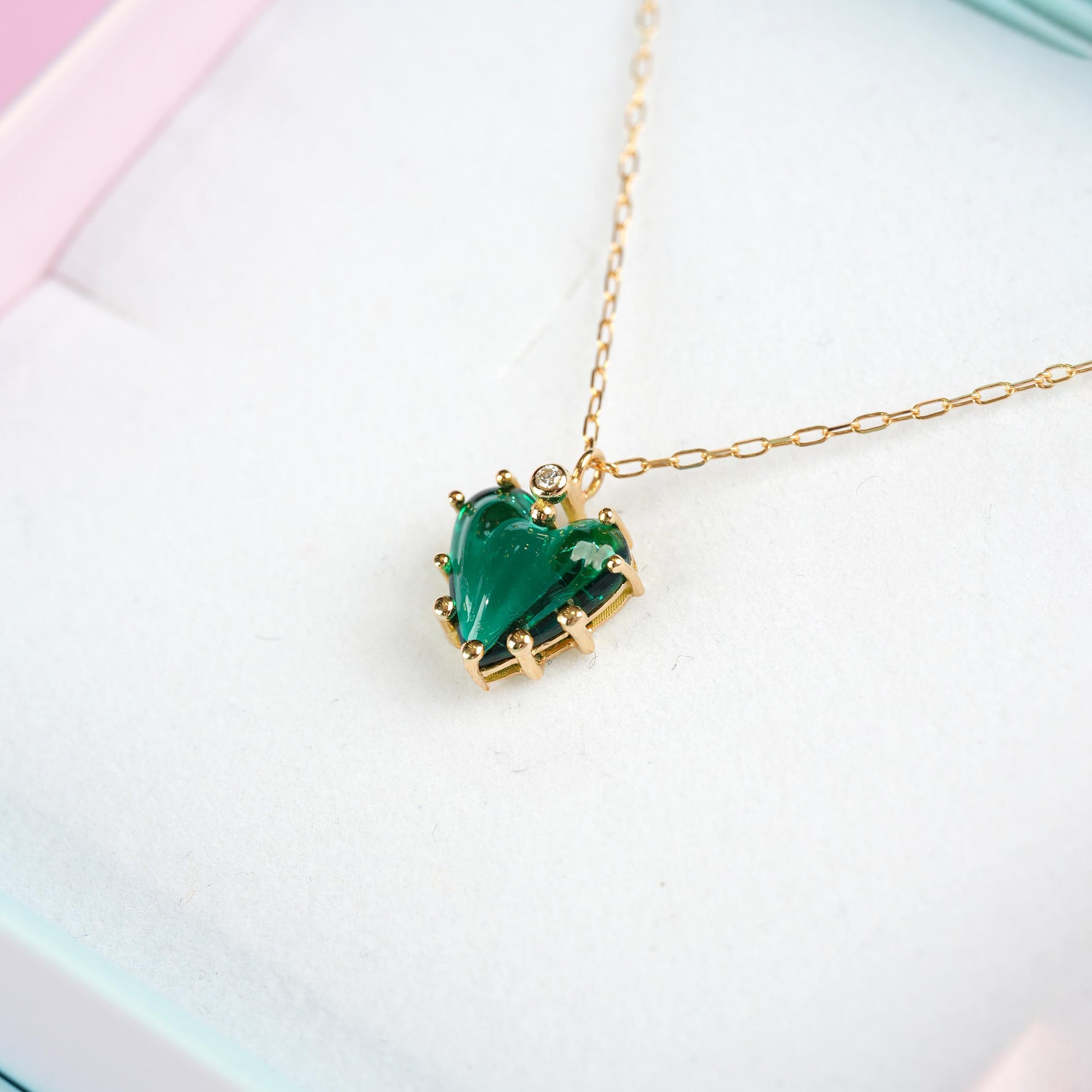 Necklace with a green heart-shaped pendant on a light background