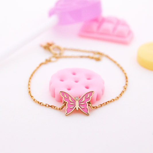 18K Gold pink butterfly bracelet with gold wings and a diamond center on a yellow gold chain. Baby Gifts