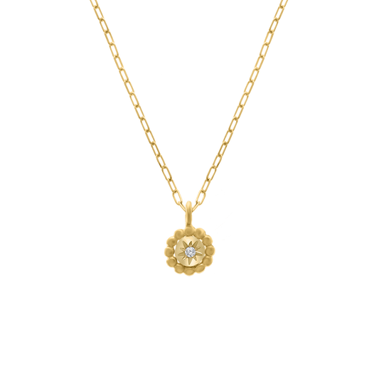 Mini Stellar Coin Necklace featuring a round beaded-edge pendant in 18K gold, with a sparkling diamond starburst design at its center, suspended on a delicate chain.