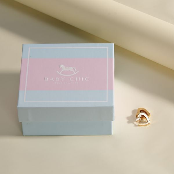 Open heart gold stud earrings displayed next to BabyChic gift box