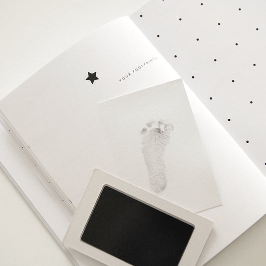 Baby journal footprint page with clean-touch ink pad and tiny foot imprint