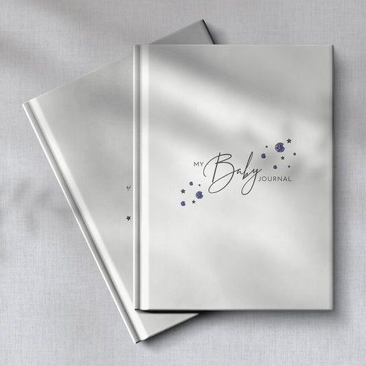 Two amethyst baby journals with soft fabric background.