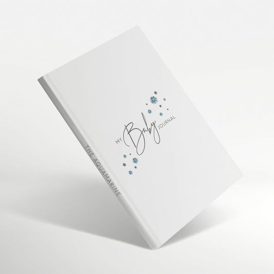 White baby journal with aquamarine birthstone illustration on the cover