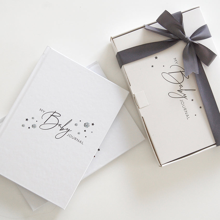 Baby journal gift set with ribbon-wrapped box and two white journals
