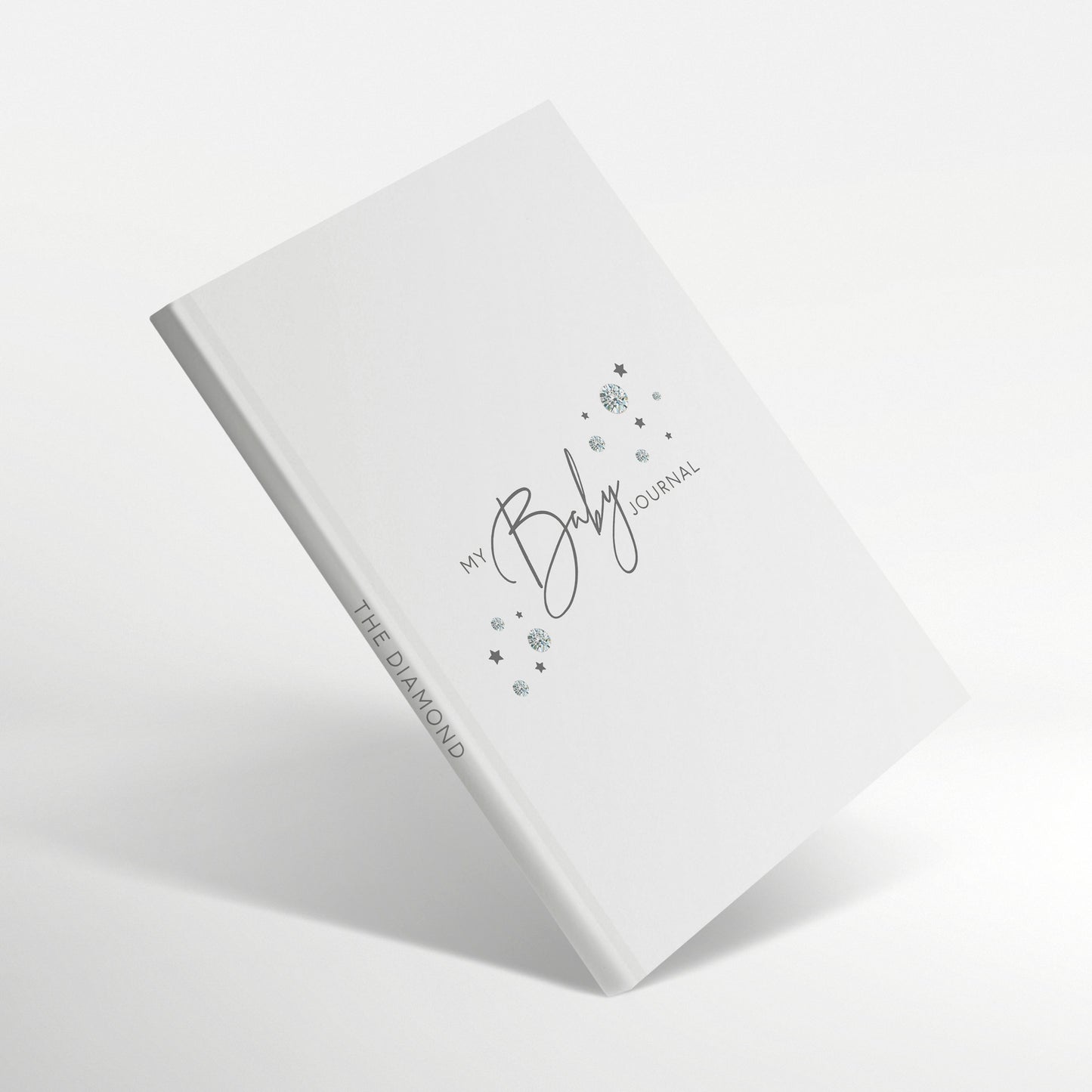 White baby journal with diamond-inspired gemstones on the cover.