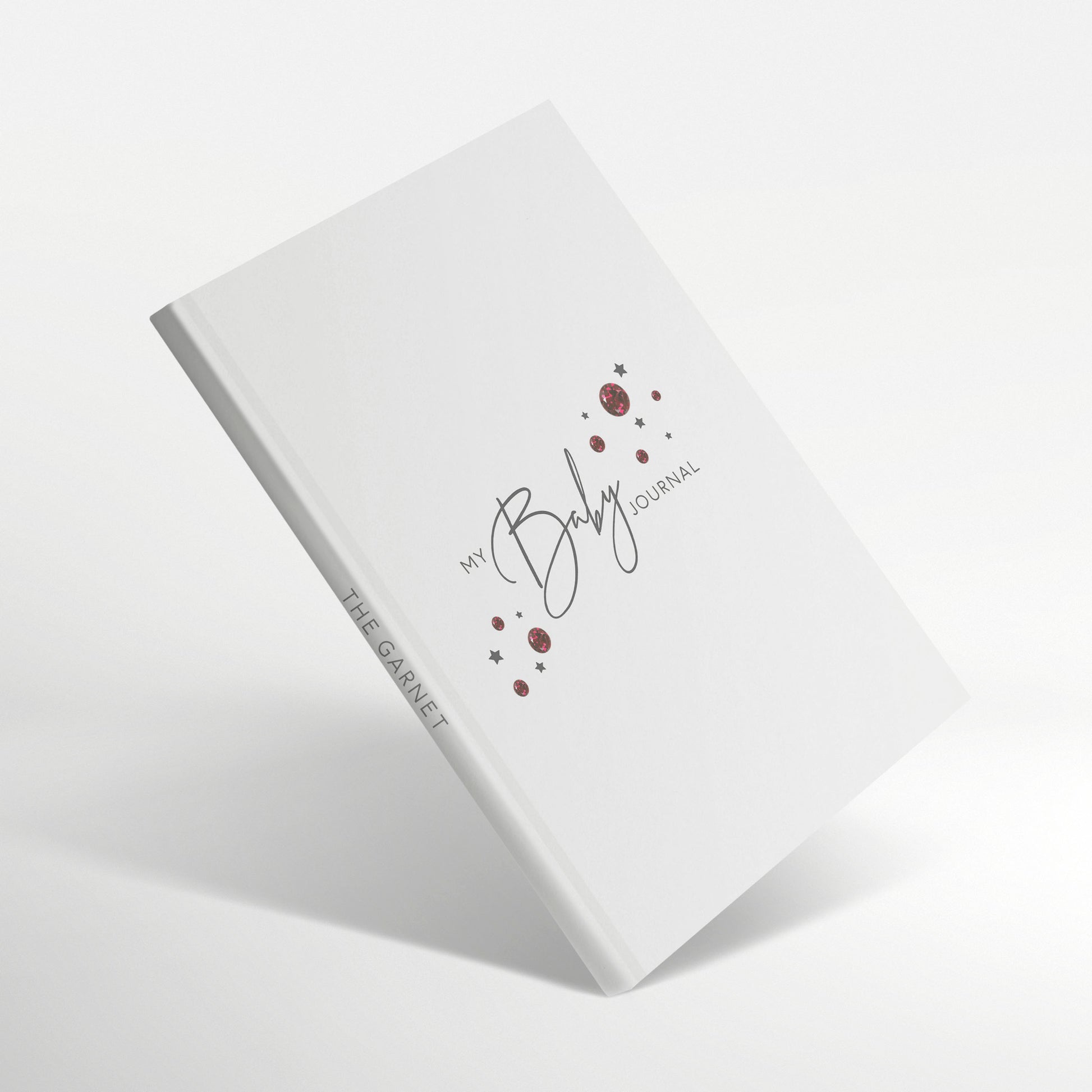 White baby journal with garnet birthstone design and 'The Garnet' spine title