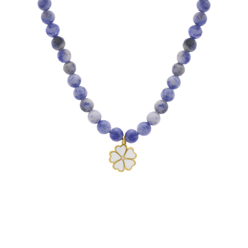 Purple and blue beaded necklace with a white enamel four-leaf clover charm featuring a tiny diamond at the center, displayed on a white background.