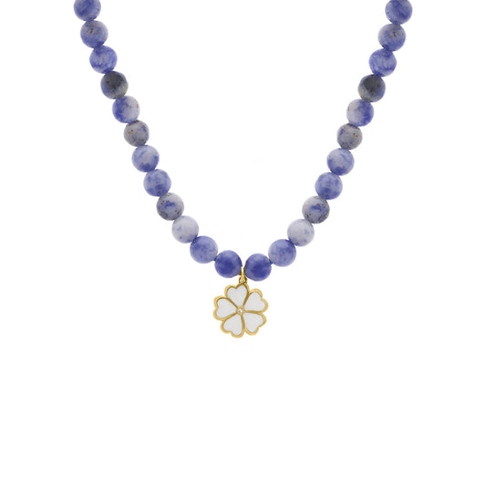 Purple and blue beaded necklace with a white enamel four-leaf clover charm featuring a tiny diamond at the center, displayed on a white background.