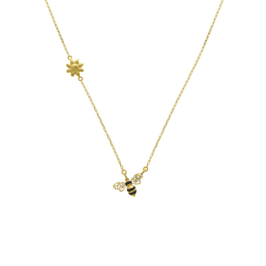 Gold necklace featuring a daisy charm on one side and a black-and-yellow enamel bee with a diamond accent on the other, displayed on a white background.