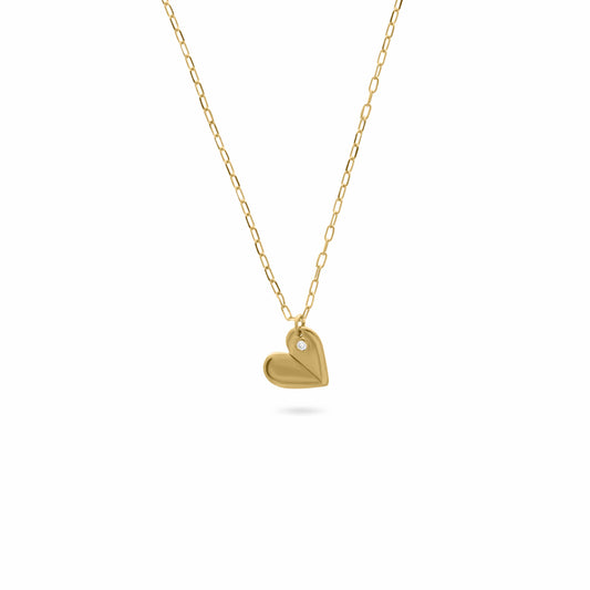 Gold necklace with a folded heart-shaped pendant featuring a small diamond, displayed on a white background.