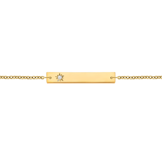 A delicate 18K yellow-gold horizontal bar bracelet on a fine paper-clip chain, featuring a starburst engraving set with a single round brilliant-cut diamond at one end, shown on a transparent background.