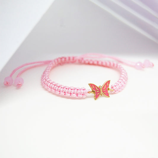 Joy Butterfly Bracelet featuring a pink macrame band and butterfly enamel charm in 18K gold