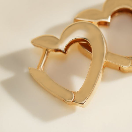 Yellow gold open heart stud earrings close up view