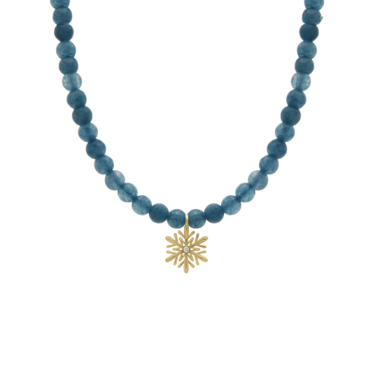 Children’s necklace with soft blue round beads and a gold snowflake pendant featuring a central diamond, displayed on a transparent background.