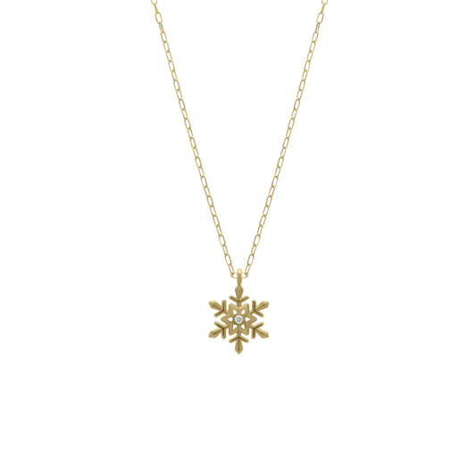 Gold necklace featuring a snowflake-shaped pendant with a small diamond in the center, displayed on a transparent background.