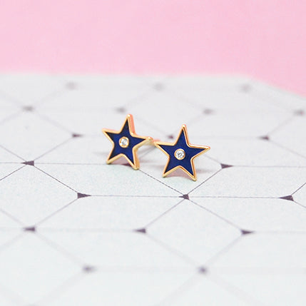 Blue enamel star earrings with diamonds on geometric background