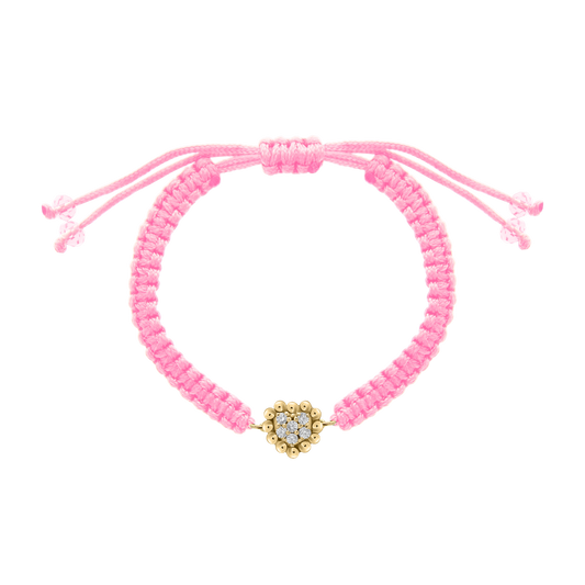 Pink cord bracelet featuring a heart-shaped 18K gold charm with clustered diamonds at the center, designed for children.