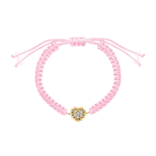 Light pink woven bracelet with a central heart-shaped diamond charm in a beaded gold setting, perfect for gifting to little ones.