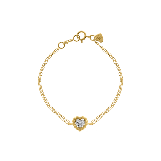 A delicate 18K yellow-gold bracelet featuring a scalloped gold-bead heart motif set with a cluster of round brilliant-cut diamonds, suspended on a fine double paper-clip chain with a spring-ring clasp and a small heart-shaped brand tag, shown on a transparent background.