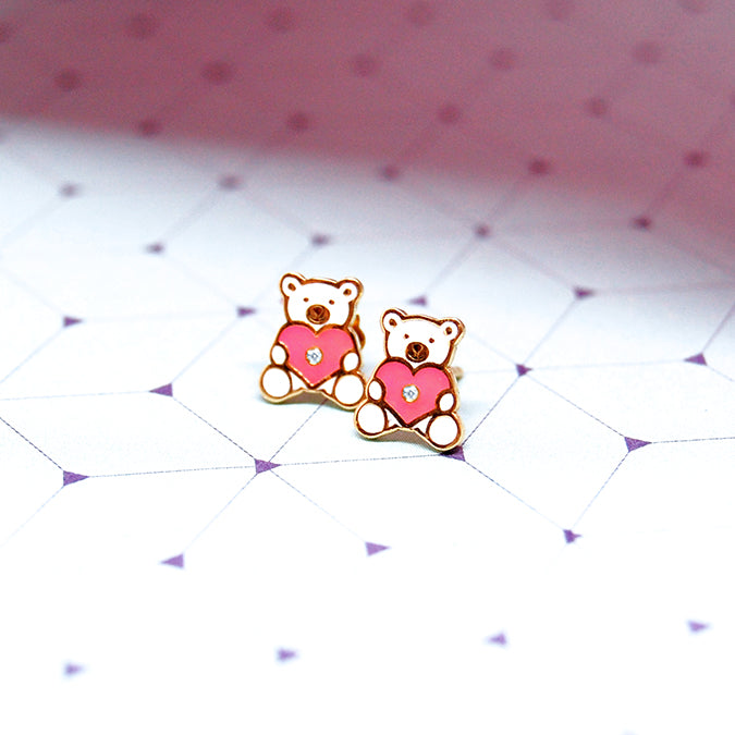 Gold teddy bear diamond earrings with pink enamel heart design