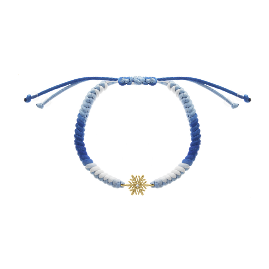 Blue braided cord bracelet with yellow gold snowflake charm and diamond center
